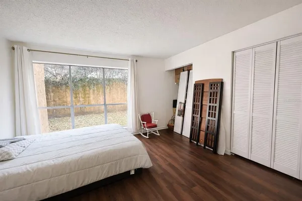 a bed room with a bed and a lamp