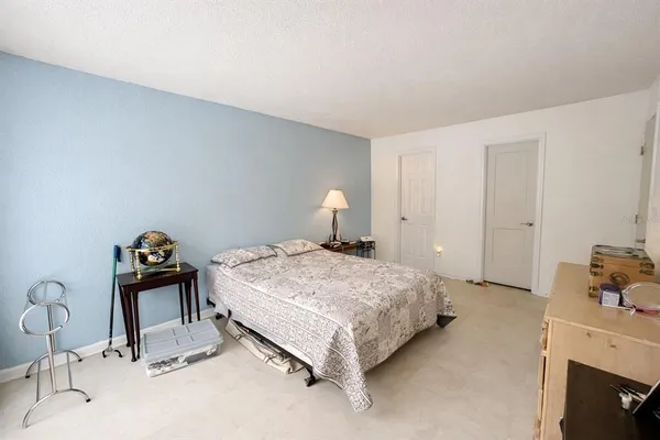 a bedroom with a bed and a dresser in it