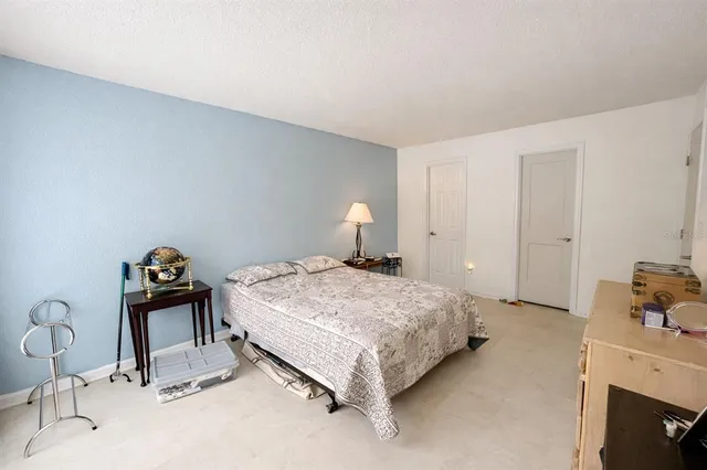 a bedroom with a bed and a dresser in it