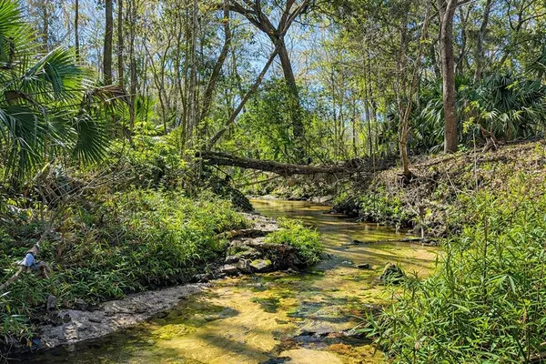 a swimming pool with outdoor seating and yard