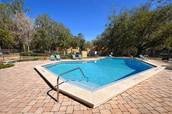 a living room with furniture floor to ceiling window and wooden floor