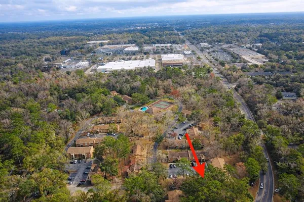 an aerial view of a house with a swimming pool and red umbrella