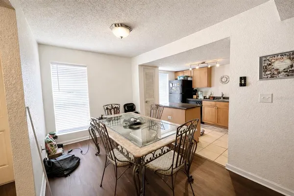 a large kitchen with a table and chairs