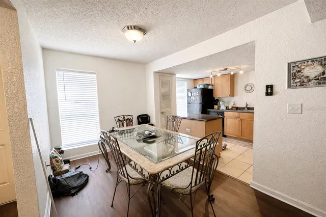 a large kitchen with a table and chairs