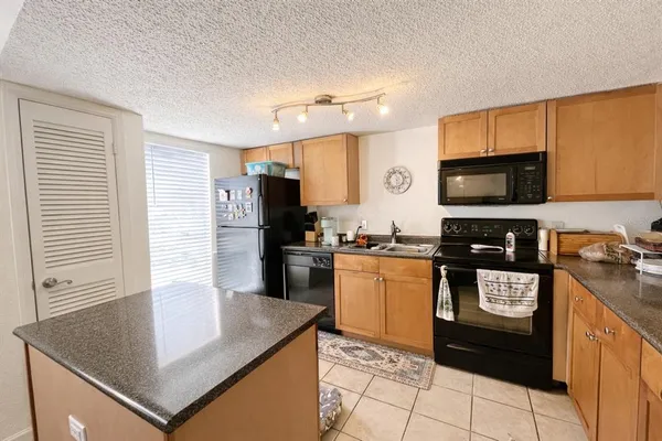 a kitchen with a sink stove and microwave