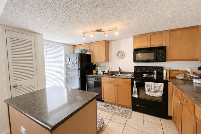 a kitchen with a sink stove and microwave