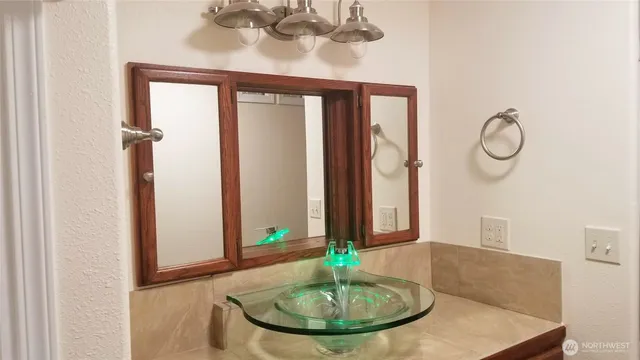 a bathroom with a mirror and a sink