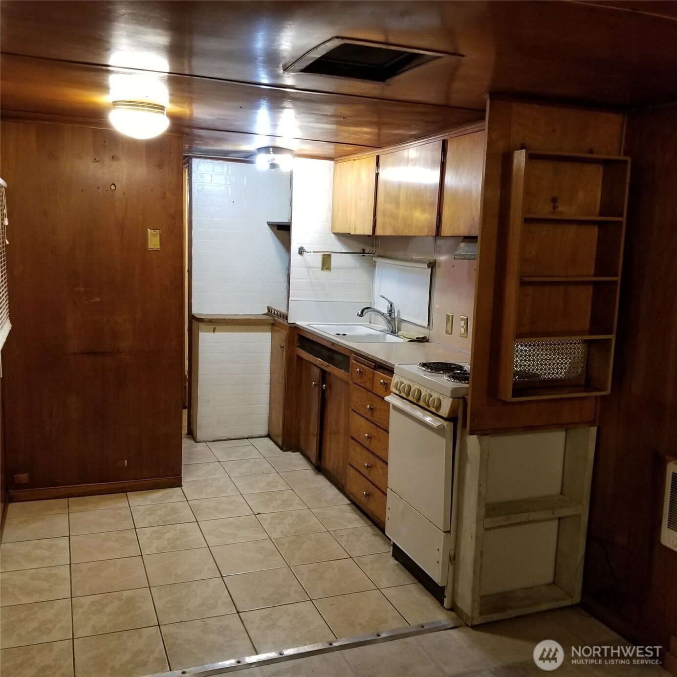 334 Devoe Street Northeast Olympia, WA 98506 - Photo 23 of 29 a kitchen with stainless steel appliances granite countertop a sink and a refrigerator