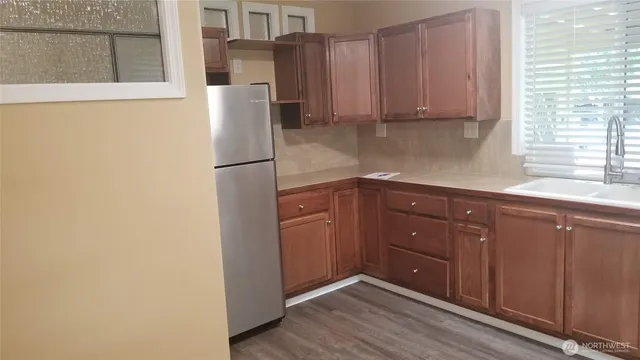 a kitchen with a refrigerator and cabinets