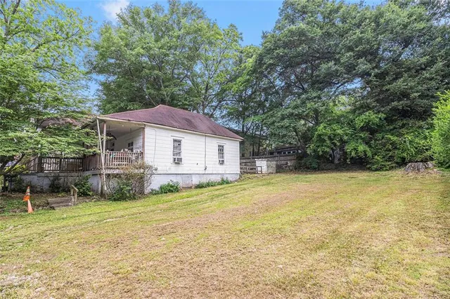 a view of a house with a yard and sitting area