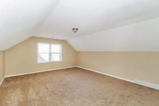 a large white kitchen with stainless steel appliances granite countertop a stove a sink and a refrigerator