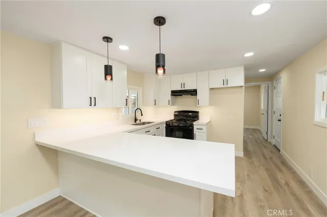 a kitchen with kitchen island a counter top space appliances and cabinets