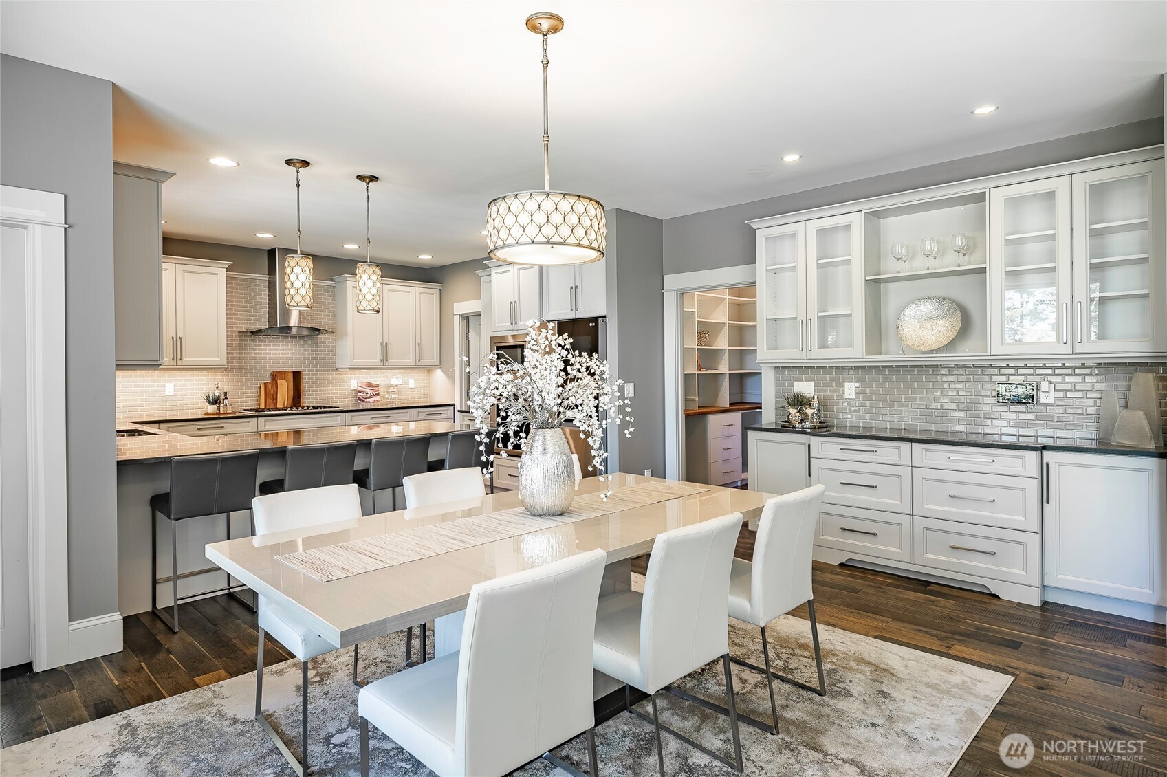9125 Shearwater Road Blaine, WA 98230 - Photo 12 of 40 a kitchen with a dining table chairs sink and cabinets