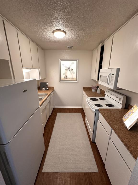 4639 Williams Road, Unit 205 Benbrook, TX 76116 - Photo 4 of 11 Kitchen with refrigerator, oven, stove, microwave and garbage disposal