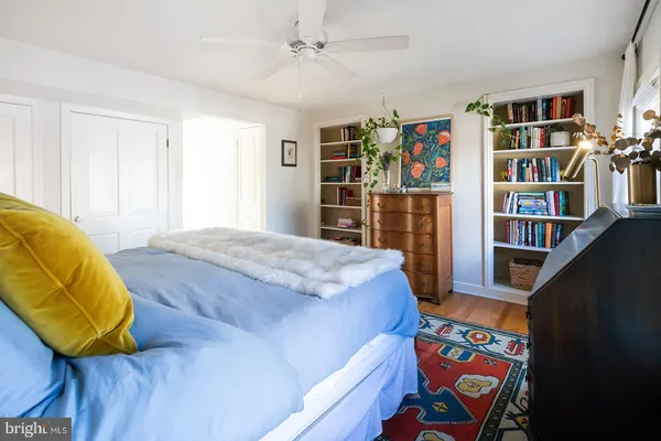 a bedroom with a bed and a book shelf