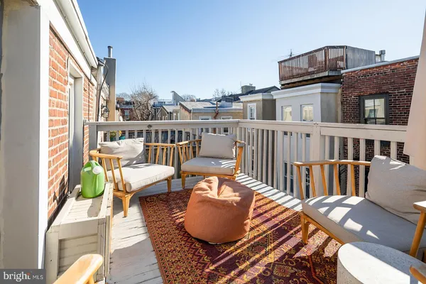 a balcony with table and chairs