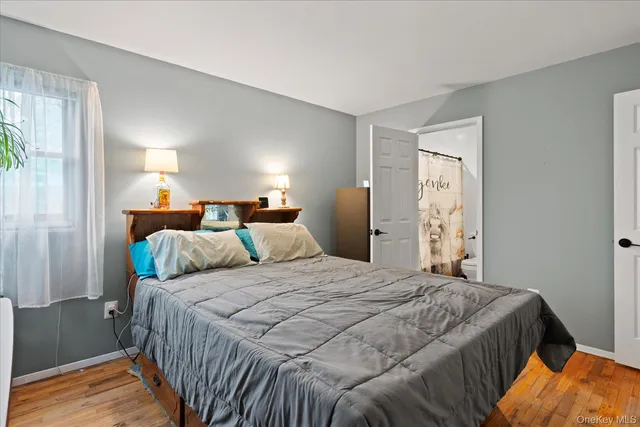 a bedroom with a bed and a lamp