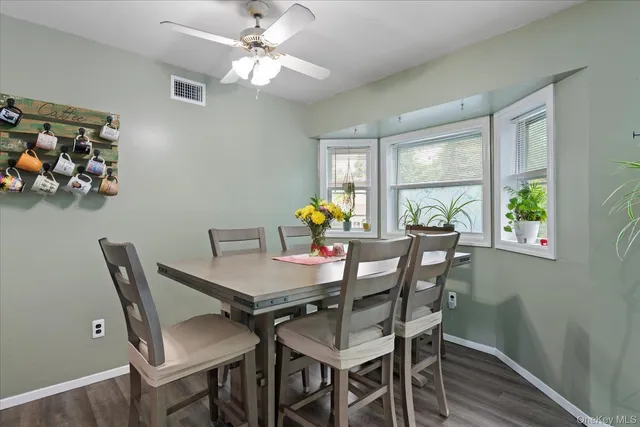 a view of a dining room with furniture a chandelier and wooden floor