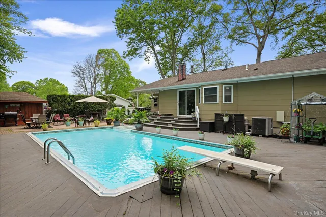 an outdoor view of swimming pool with outdoor seating