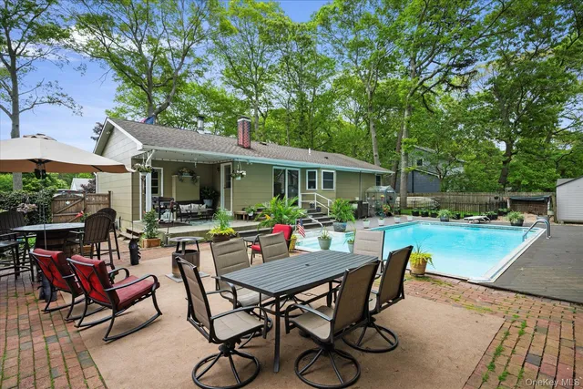 a view of a patio with table and chairs and potted plants