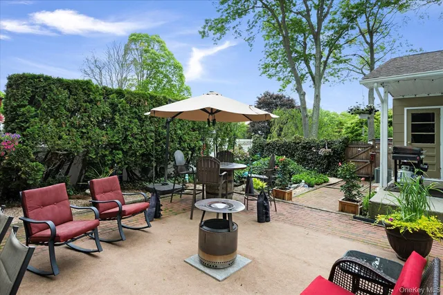a view of a patio with furniture and a fire pit