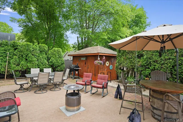 an outdoor space with patio and wooden floor