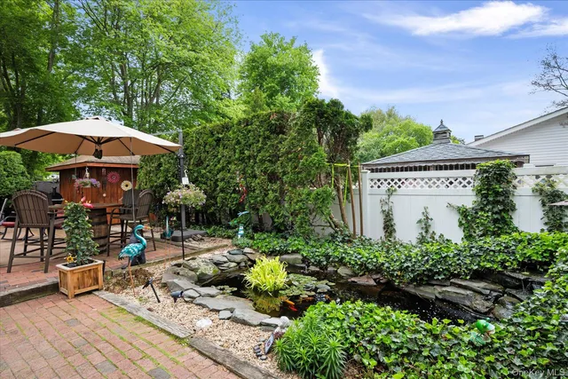 a view of a house with garden and sitting area