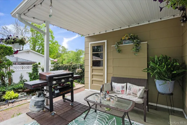 a view of a patio with table and chairs potted plants with wooden floor