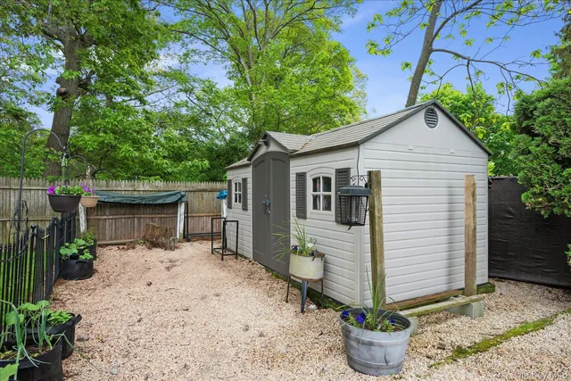 a white house with trees in front of it