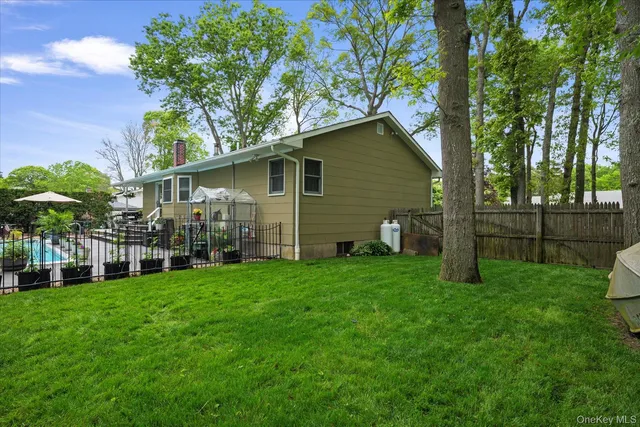a backyard of a house with table and chairs