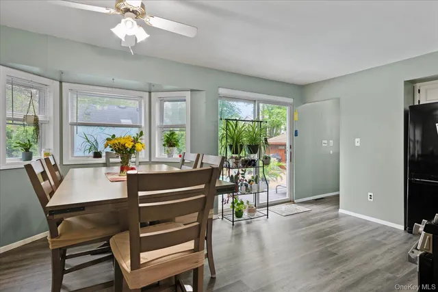 a view of a dining room with furniture window and wooden floor