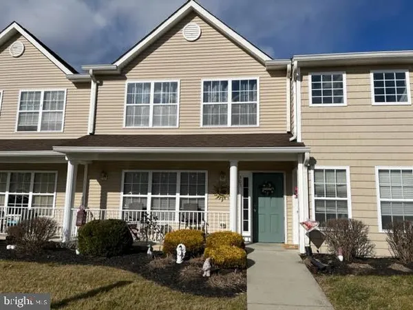 a front view of a house with lots of windows and yard