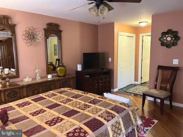 a bedroom with a bed and a dresser in it