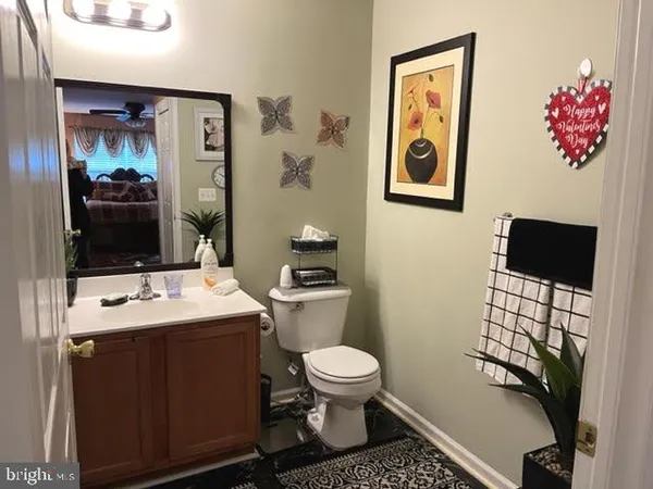 a bathroom with a toilet a sink and mirror