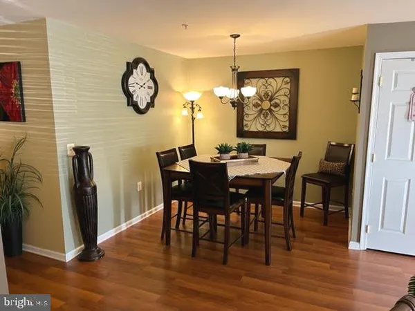 a view of a dining area with furniture and wooden floor