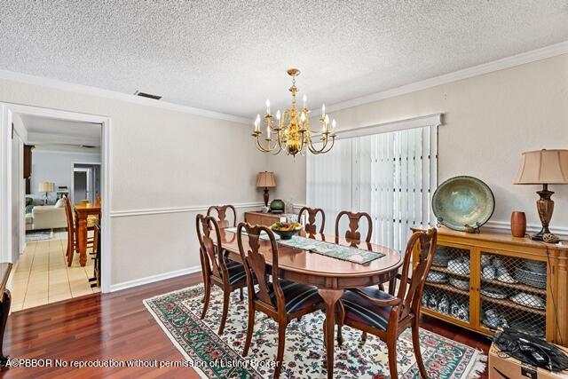 14 Bamboo Lane Jupiter, FL 33458 - Photo 12 of 33 a dining room with furniture and chandelier
