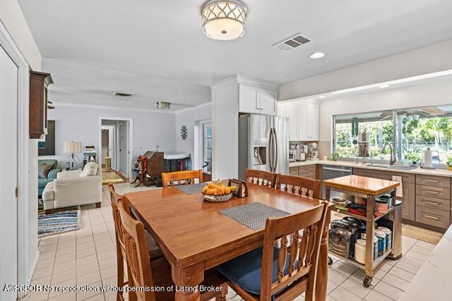14 Bamboo Lane Jupiter, FL 33458 - Photo 15 of 33 a dining room with furniture a rug and a large window