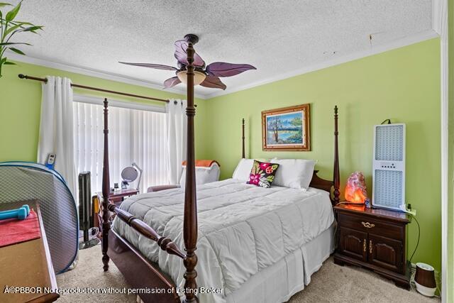 14 Bamboo Lane Jupiter, FL 33458 - Photo 22 of 33 a bedroom with a bed and a chandelier