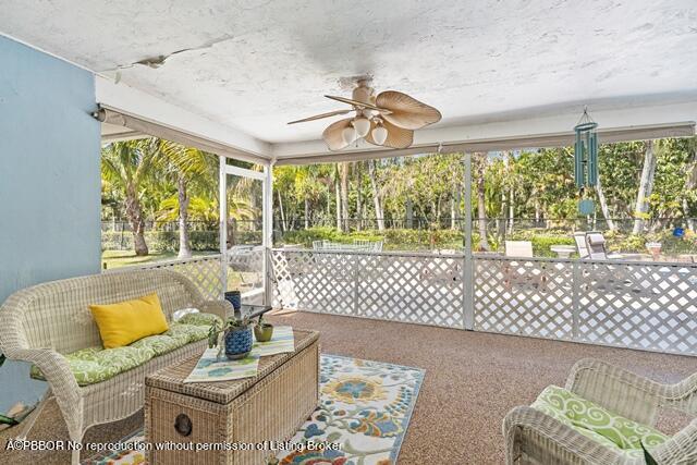 14 Bamboo Lane Jupiter, FL 33458 - Photo 24 of 33 a living room with furniture and a large window