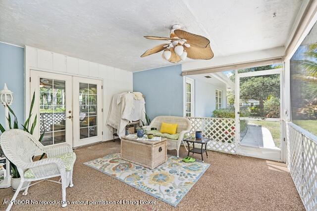 14 Bamboo Lane Jupiter, FL 33458 - Photo 25 of 33 a living room with furniture a rug and a floor to ceiling window