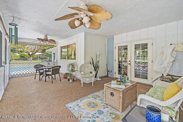 14 Bamboo Lane Jupiter, FL 33458 - Photo 26 of 33 a living room with furniture chandelier and large window