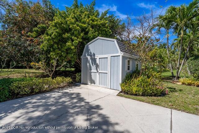 14 Bamboo Lane Jupiter, FL 33458 - Photo 29 of 33 a front view of a house with a garden