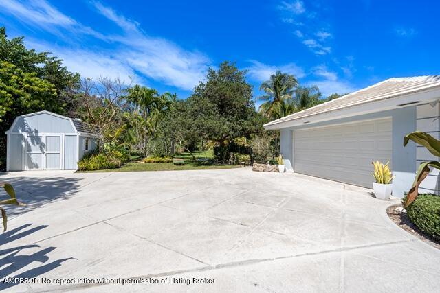 14 Bamboo Lane Jupiter, FL 33458 - Photo 30 of 33 a view of a backyard of the house