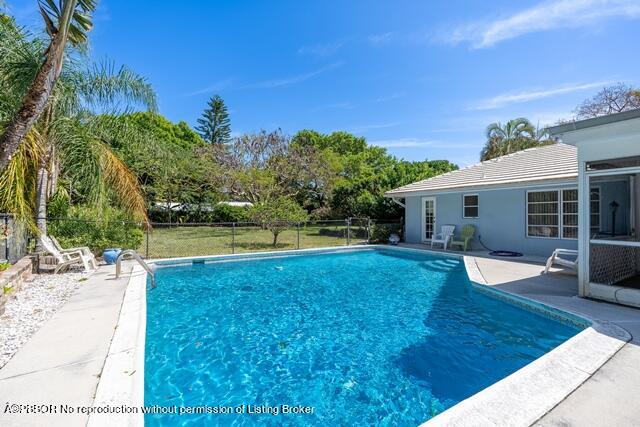 14 Bamboo Lane Jupiter, FL 33458 - Photo 6 of 33 a view of a house with a backyard porch and sitting area