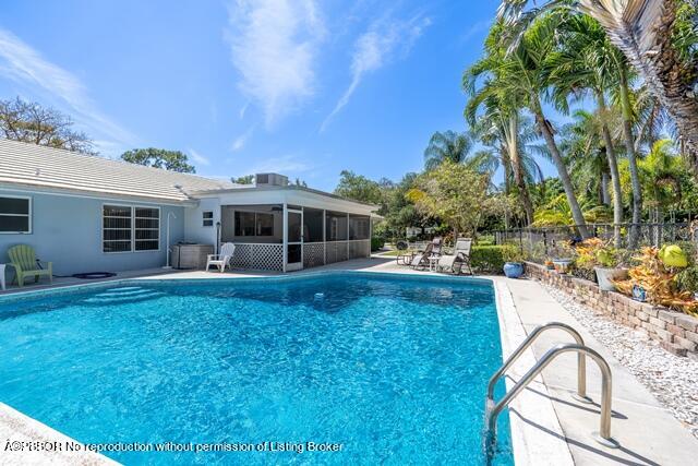 14 Bamboo Lane Jupiter, FL 33458 - Photo 7 of 33 a view of a house with backyard and sitting area