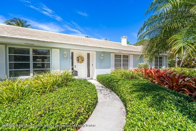 14 Bamboo Lane Jupiter, FL 33458 - Photo 9 of 33 front view of a house with a yard