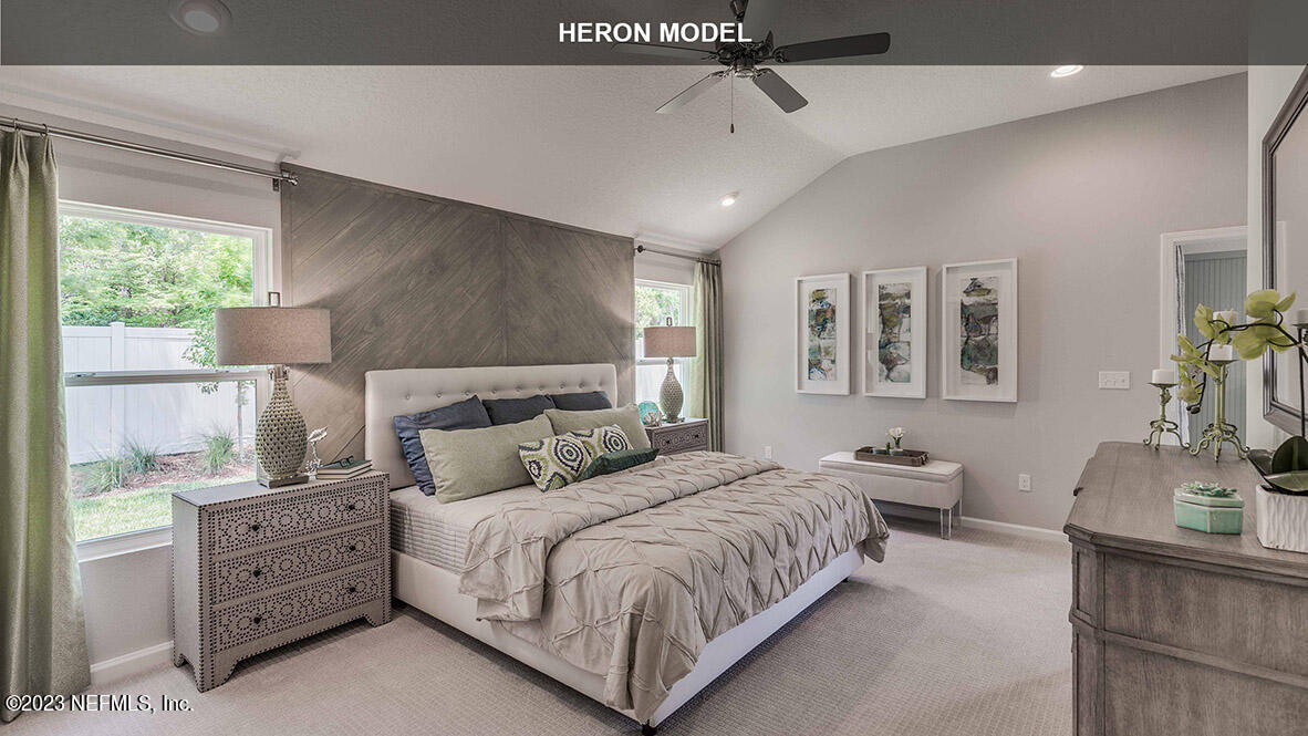 65744 Edgewater Drive Yulee, FL 32097 - Photo 13 of 45 a bedroom with a large bed and a window