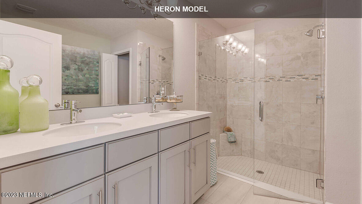 65744 Edgewater Drive Yulee, FL 32097 - Photo 14 of 45 a bathroom with a double vanity sink mirror and shower