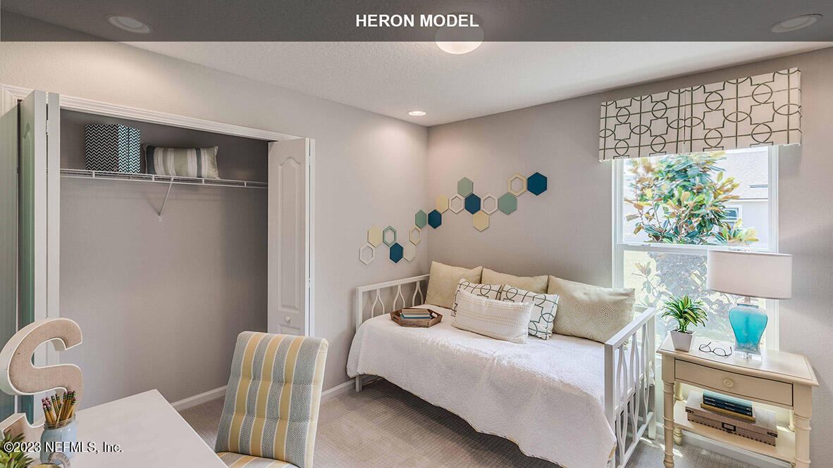 65744 Edgewater Drive Yulee, FL 32097 - Photo 15 of 45 a bedroom with a bed and a window