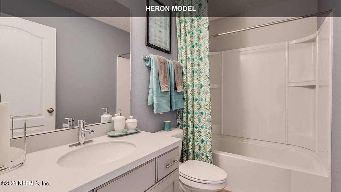 65744 Edgewater Drive Yulee, FL 32097 - Photo 16 of 45 a bathroom with a sink toilet and shower